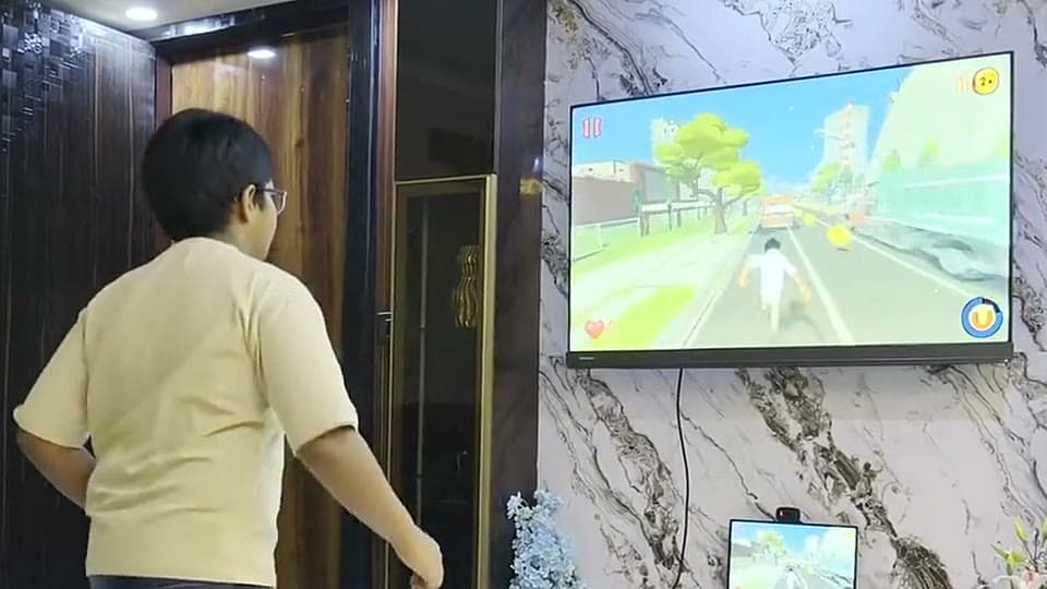 A player jumping in their living room, playing Zombie Run on the TV