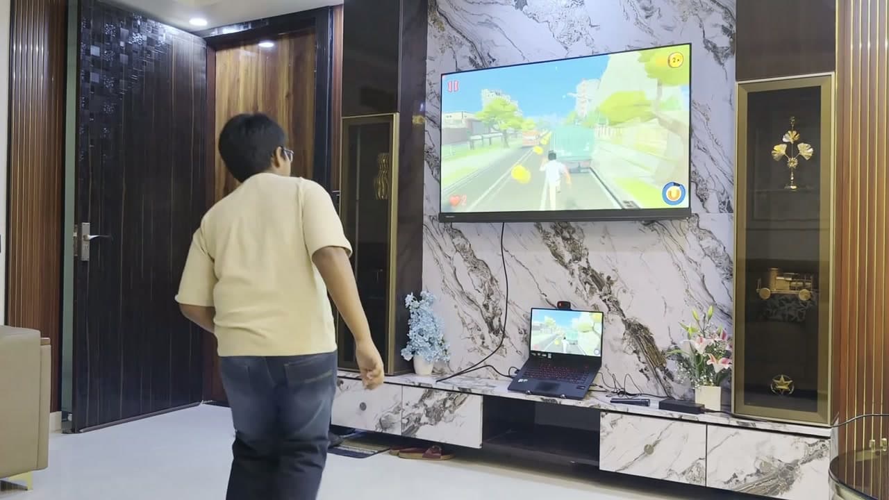 A player ducking in front of the TV while playing Zombie Run